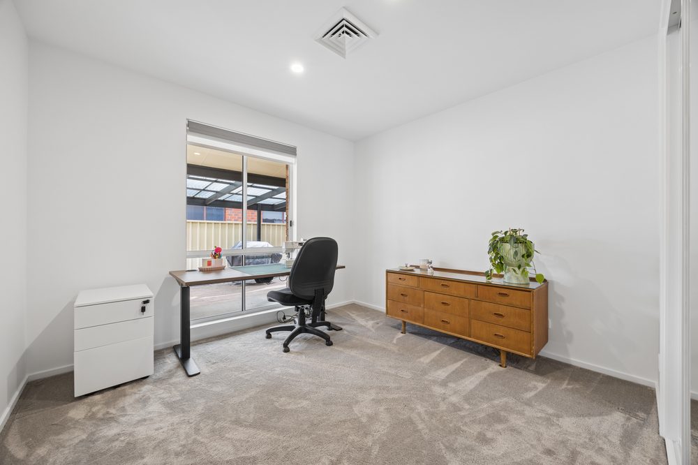 Bedroom set up as a study with a desk and chair
